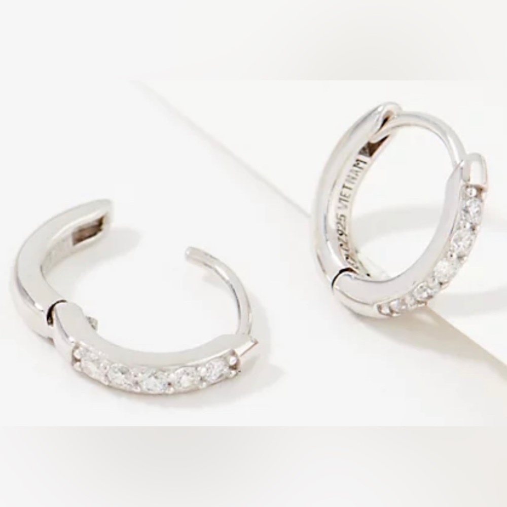Diamonique silver huggie earrings.